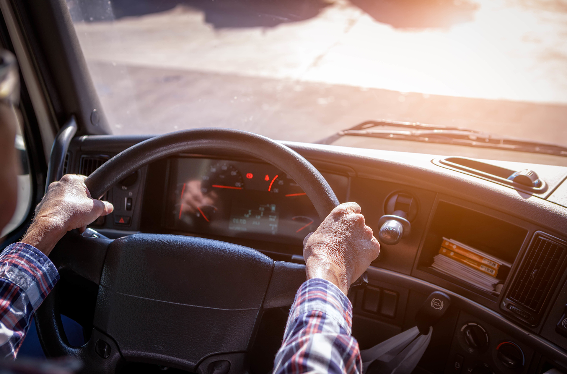 person's hand on truck steering wheel